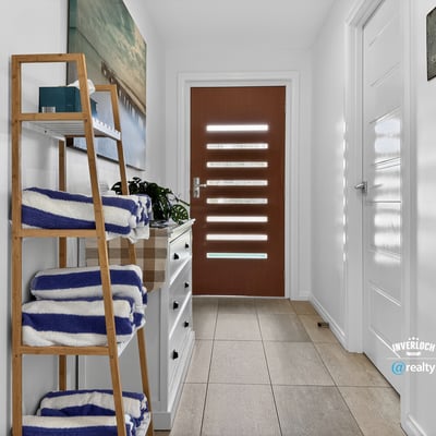 Bright and welcoming entryway featuring modern decor and practical storage solutions for your convenience.