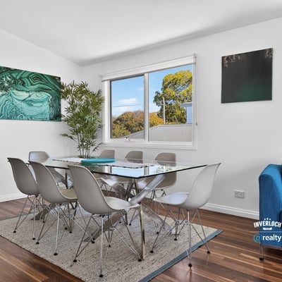 Bright dining area features modern furnishings, large windows, and a contemporary touch, perfect for gatherings.