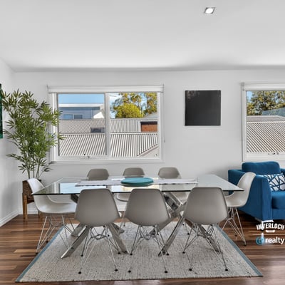 Bright dining area featuring large windows, modern furnishings, and an inviting atmosphere perfect for gatherings.