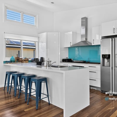 Modern kitchen featuring sleek cabinetry, vibrant backsplash, and functional layout ideal for entertaining.