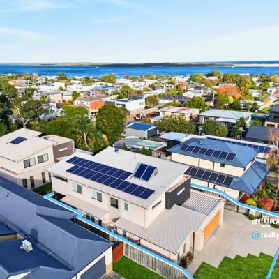 Modern home featuring solar panels and picturesque views, nestled in a vibrant coastal community.