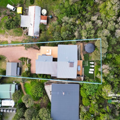 Spacious property surrounded by greenery, featuring ample outdoor space and convenient access to main roads.