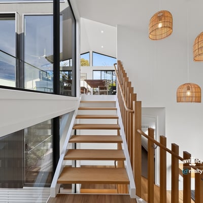 Contemporary design meets natural light in this spacious staircase, highlighting a seamless transition between levels.