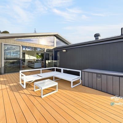 Spacious outdoor deck with modern seating, perfect for entertaining and enjoying views in a contemporary setting.
