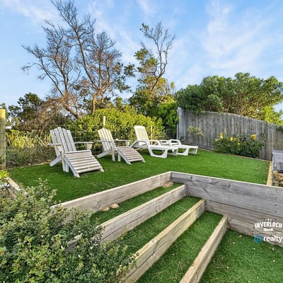Discover a peaceful outdoor retreat featuring landscaped steps and ample seating for relaxation and enjoyment.