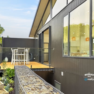 Modern home featuring an expansive deck, perfect for outdoor dining and enjoying scenic views.