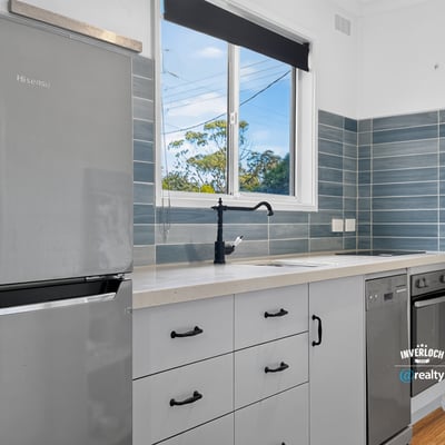 Modern kitchen featuring sleek appliances, ample storage, and natural light, perfect for culinary enthusiasts.