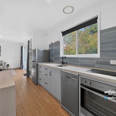 Discover a modern kitchen featuring sleek cabinetry, updated appliances, and abundant natural light throughout the space.
