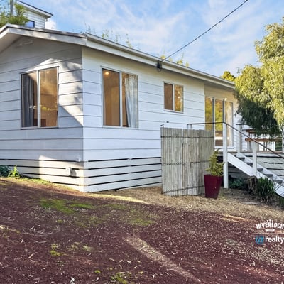 This inviting home features a spacious layout with large windows and a private outdoor area.