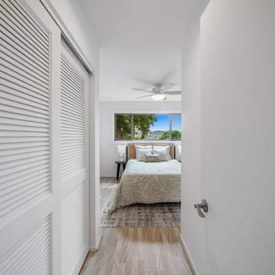 Modern bedroom featuring large windows, providing ample natural light and a refreshing outdoor view.