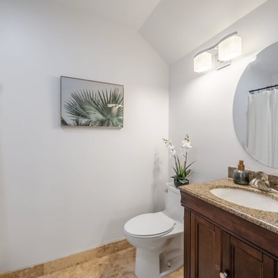 Bright and inviting bathroom featuring modern fixtures, a large mirror, and tasteful decor accents.
