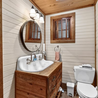 Cozy bathroom featuring a double sink vanity, natural wood accents, and soft lighting for a warm ambiance.
