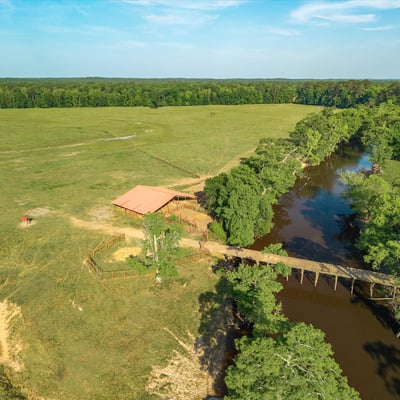 Spacious acreage with a scenic river and outbuilding, perfect for recreational or agricultural opportunities.