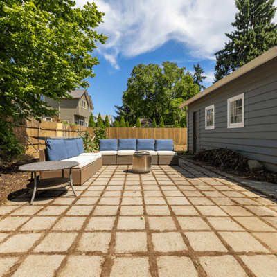 Inviting outdoor space featuring a cozy seating area, perfect for relaxing and entertaining in the sun.