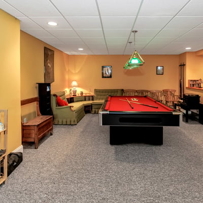 The lower-level Game Room is a wonderful space to enjoy a round of pool or relax and listen to music.