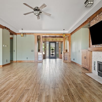 A custom fireplace, built-in cabinetry, and architectural wood accents anchor this living space, offering both style and comfort in a well-appointed Phoenix home.
