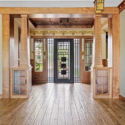 Inviting entryway showcasing handcrafted woodwork, built in storage, and a custom iron front door. This Phoenix home delivers standout architectural style and premium craftsmanship from the moment you arrive.