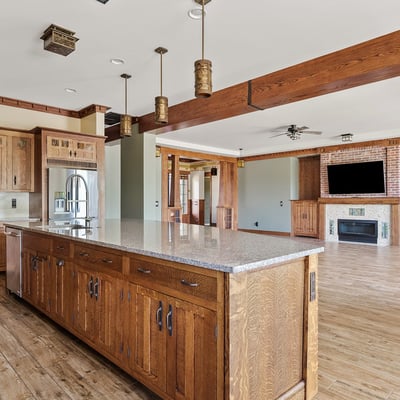 Wide open kitchen and living area showcasing wood beams, cohesive finishes, and generous square footage. A hallmark of this Phoenix home s thoughtful open concept design.