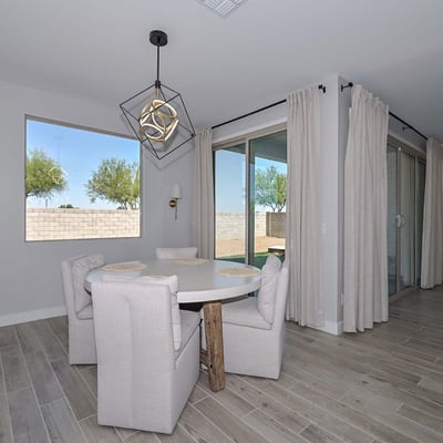 Tucked beside large windows and sliders, this intimate dining area invites sunlight and backyard views, perfect for morning meals or relaxed evenings.