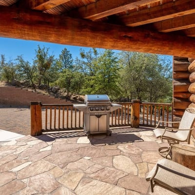 Stone patio with grill station and seating area, designed for entertaining and enjoying Prescott s outdoor lifestyle.