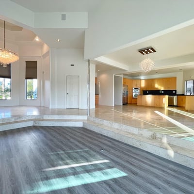 Inviting living room with contemporary finishes, expansive windows, and effortless connection to outdoor spaces and pool views.