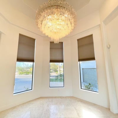 Graceful dining area framed by tall windows and a sparkling chandelier, creating a luxurious setting for intimate gatherings.