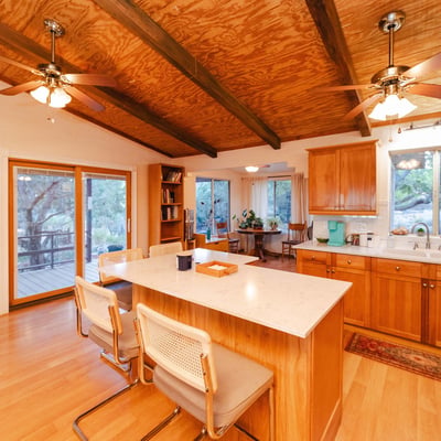 This spacious deck offers the perfect setting for open-air dining and quiet evenings surrounded by mountain views. With multiple seating options and a peaceful desert backdrop, it enhances the home s inviting Hackberry lifestyle.