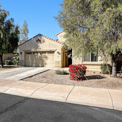 Single-level home with desert landscaping, attached garage, and clean architectural lines, offering both style and convenience.