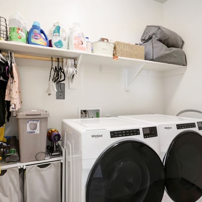 Laundry room with shelving and appliance space, designed to keep daily routines organized and efficient.