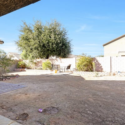 Sliding door view highlighting the expansive backyard and natural light, enhancing the home s open and airy feel.