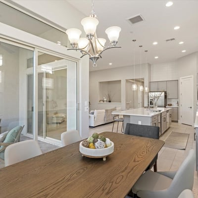 Dining area bathed in natural light, enhanced by tall windows and modern finishes, creating a warm and welcoming atmosphere.