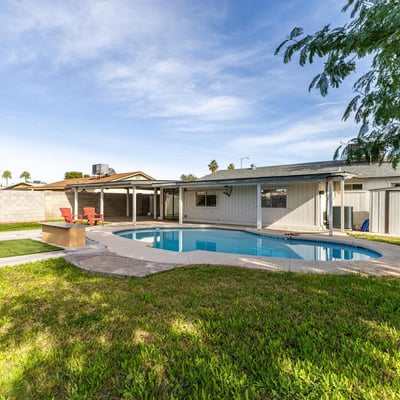 Private backyard escape featuring a sparkling pool, covered patio shade, and plenty of space to unwind enjoy outdoor comfort and entertaining in Phoenix.