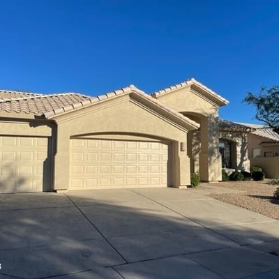 Wide driveway leading to a three-car garage, offering excellent parking and storage options. A valuable feature for buyers seeking functionality and space.