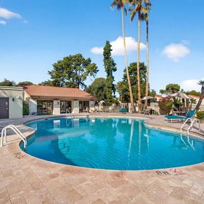 Spacious community pool area offering shaded seating, open sun areas, and a welcoming environment for leisure and relaxation.