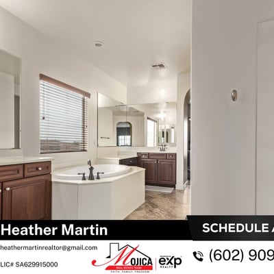 This expansive primary bathroom showcases dual vanities, soaking tub, and separate shower. Tile flooring and ample cabinetry enhance the comfort of this Glendale home with granite kitchen and pool.
