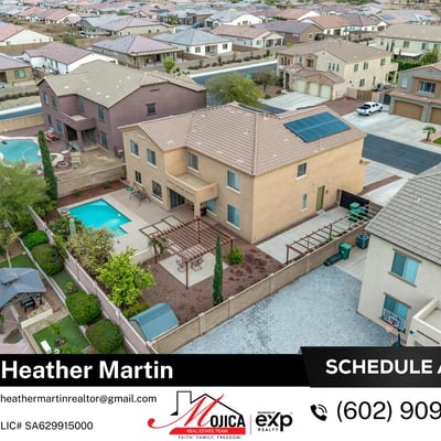 Rear aerial perspective displays the full backyard oasis with covered patio and pool. Solar panels provide energy efficiency, making this Glendale home both stylish and practical.