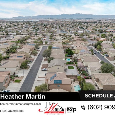 This elevated aerial image highlights the rooftop solar system and fenced backyard pool. Surrounded by desert landscaping, this Glendale home combines energy-efficient upgrades with outdoor entertaining space.