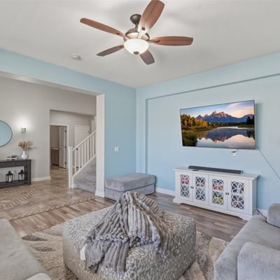 View from the living room toward the open entryway, showcasing the spacious layout, tall ceilings, and modern finishes throughout the home.