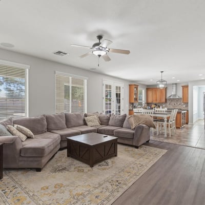 Expansive great room that flows into the kitchen and dining areas, highlighting the open floor plan that makes this Queen Creek home perfect for modern living.
