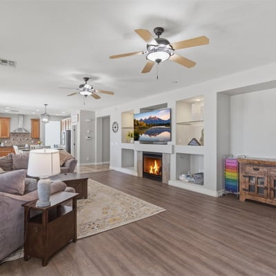 View of the large open living room connecting to the kitchen and dining areas, showcasing the modern floor plan designed for gatherings and everyday living.