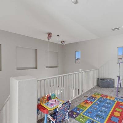 Large loft area overlooking the main entry, offering flexible space for a playroom, lounge, or second living room.