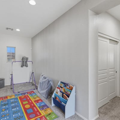 Upstairs loft and hallway connecting to bedrooms and bathrooms, providing additional living space perfect for family activities.