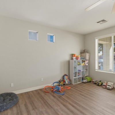 Spacious bonus room with wood-style flooring and natural light, offering flexible space for a playroom, office, or additional living area.