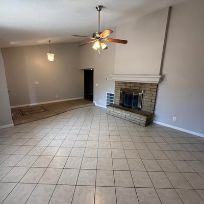 Spacious interior living and dining area with tile flooring and vaulted ceilings. The bright layout enhances the flow and livability of this Glendale home.