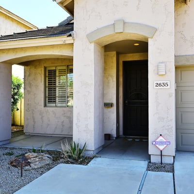 Private covered entry with elegant architectural features and shaded porch. Enhances curb appeal and welcomes guests to this Phoenix property.