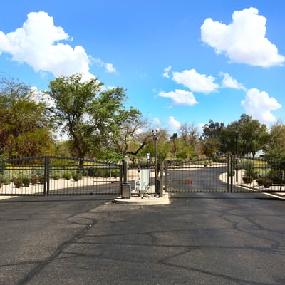 Entrance to The Fairways community featuring gated access and landscaped surroundings. This Phoenix neighborhood offers privacy and a desirable golf course setting.