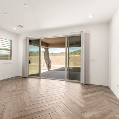Bright family room with backyard access and open layout, creating a comfortable space for relaxing and hosting guests.