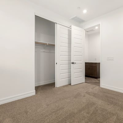 Bedroom with built-in closet and neutral design, providing flexible living space and organized storage options.