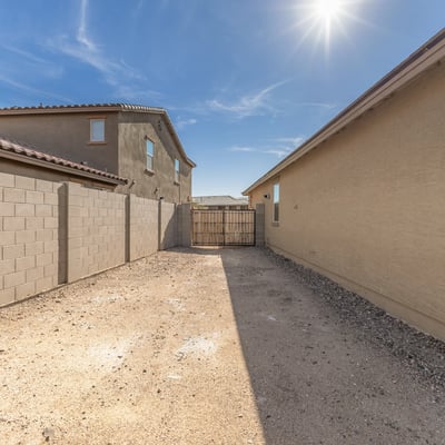 Convenient side yard access with RV gate, providing space for parking, storage, or recreational vehicle use.