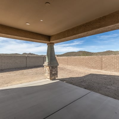 Relaxing view from covered patio overlooking large backyard, ideal for enjoying outdoor living and entertaining guests.